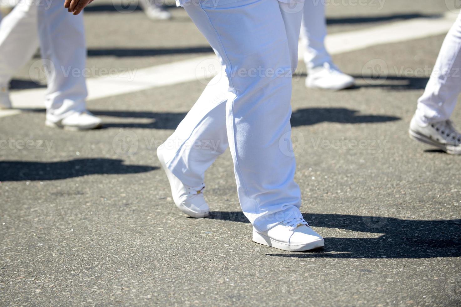 Military marching in a street. Legs and shoes in line photo