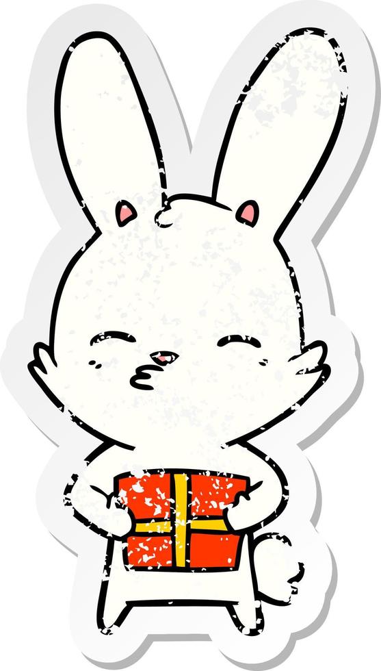distressed sticker of a curious bunny cartoon with present vector