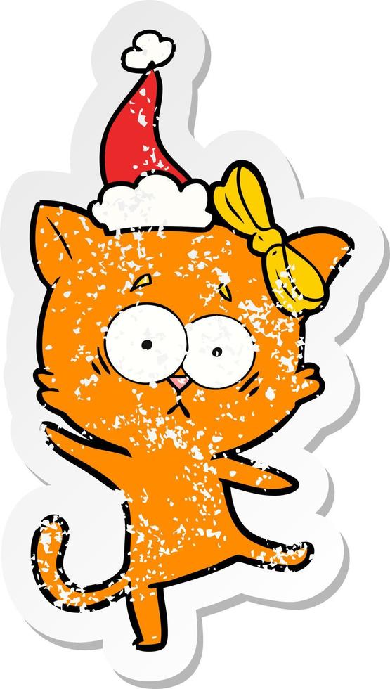 distressed sticker cartoon of a cat wearing santa hat vector