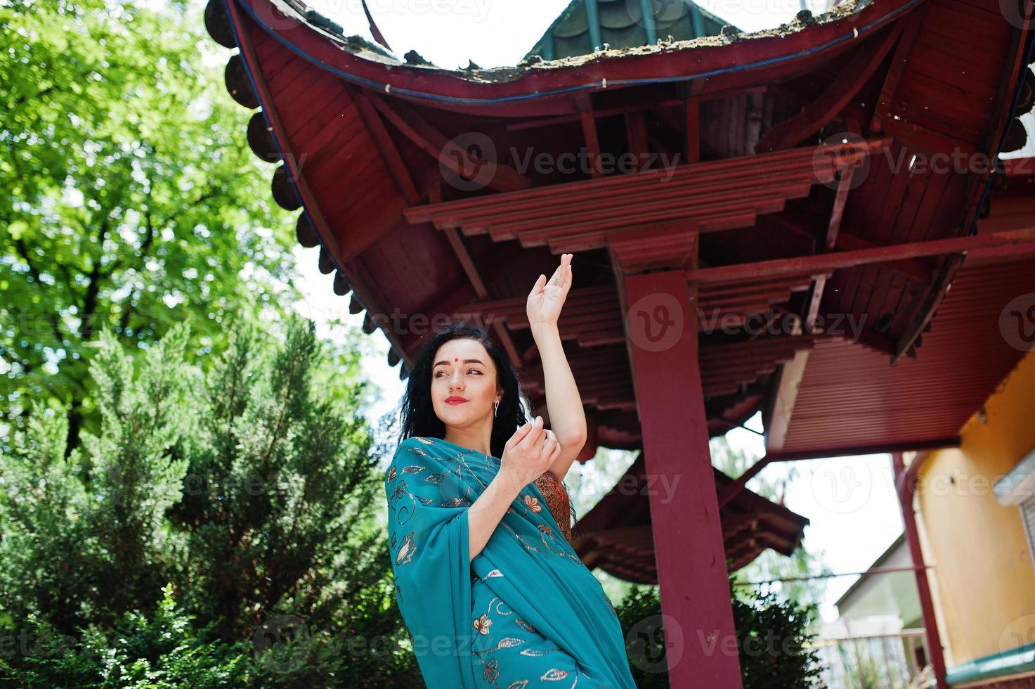 Portrait of beautiful indian brumette girl or hindu woman model against japanese traditional house. photo