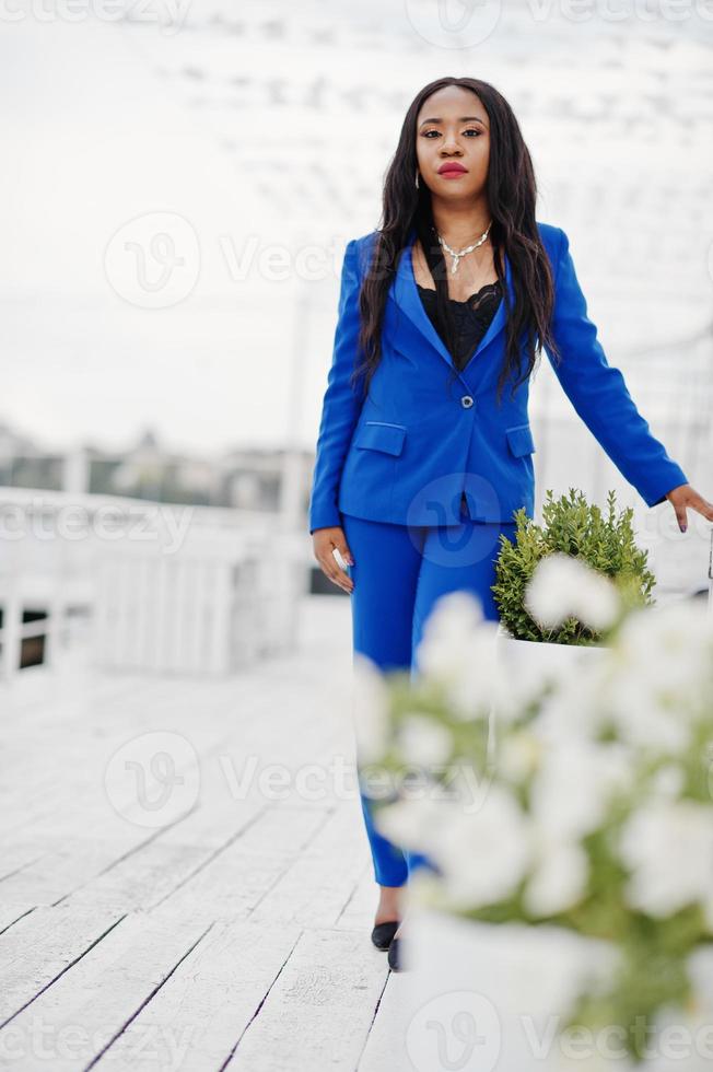 Success african american business woman at blue suit posed. photo