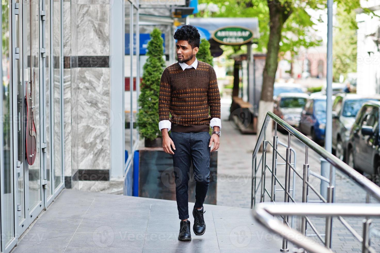 Portrait of young stylish indian man model pose in street. photo