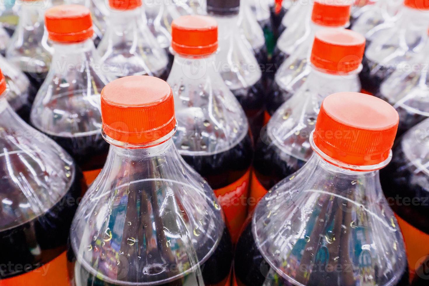 Carbonated soft drink bottles close up photo