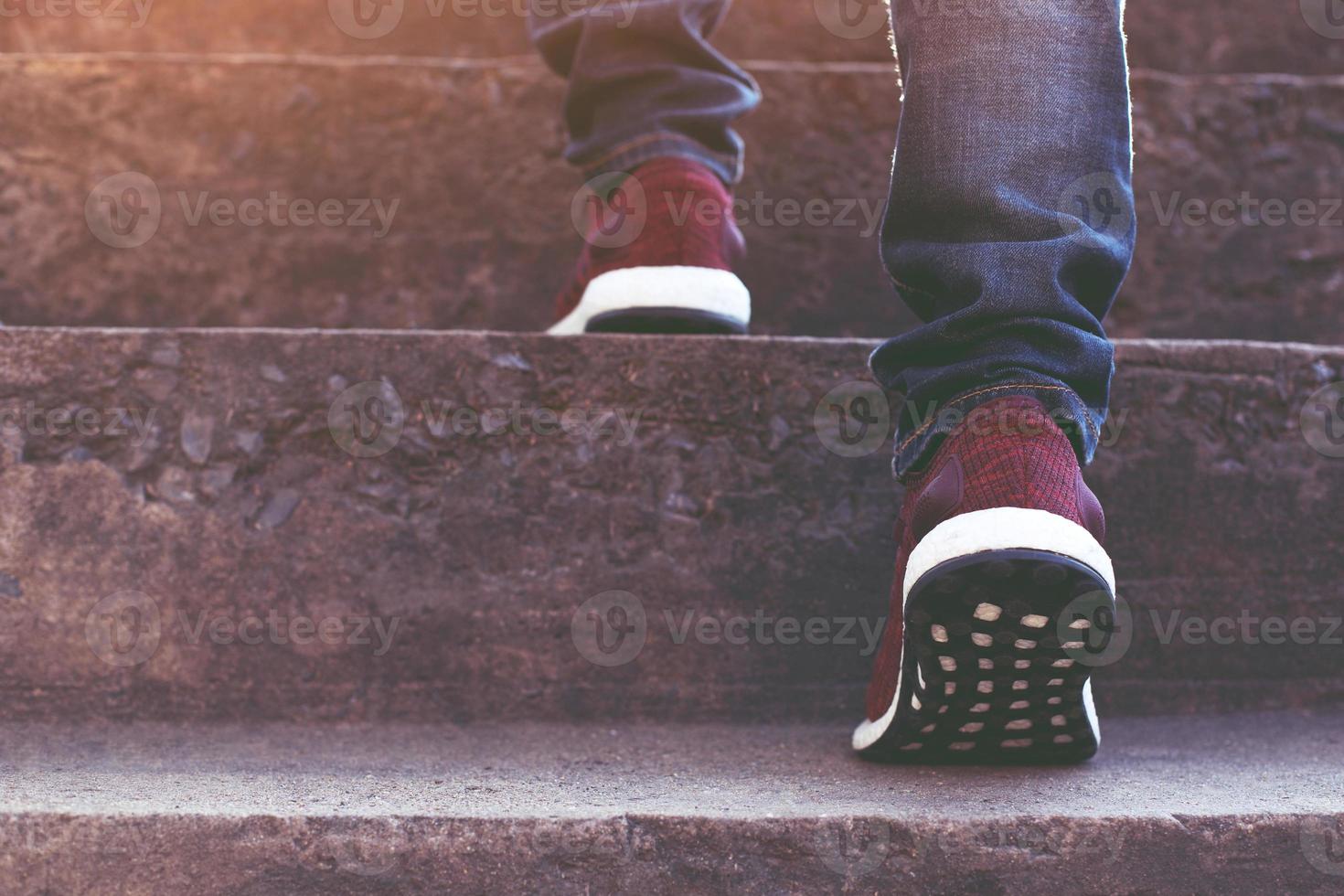 Close up legs of young hipster man One person walking stepping going up the stairs photo