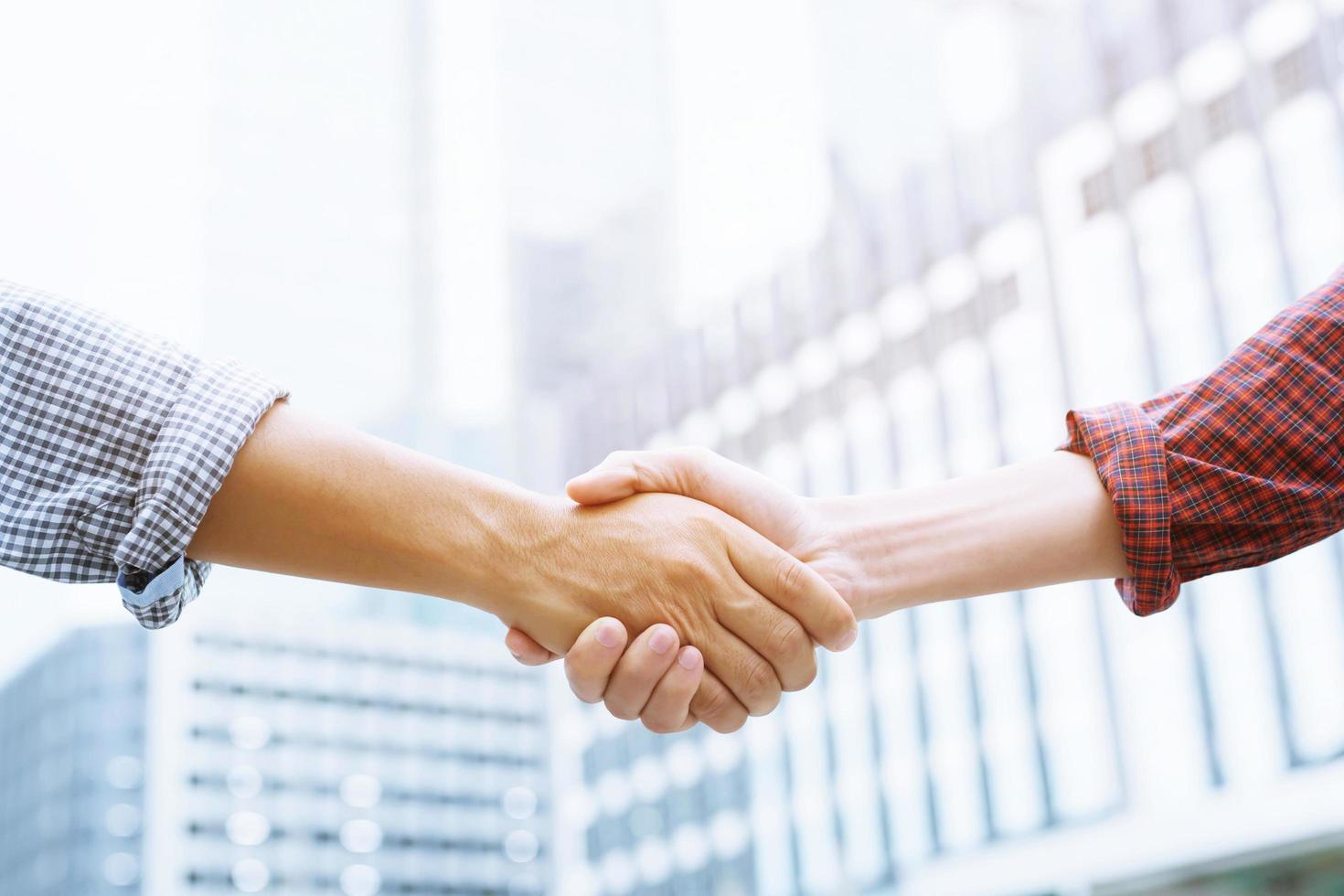 Closeup of a businessman hand shake investor between two colleagues  OK, succeed in business Holding hands. Leave space to write a description of the message. photo