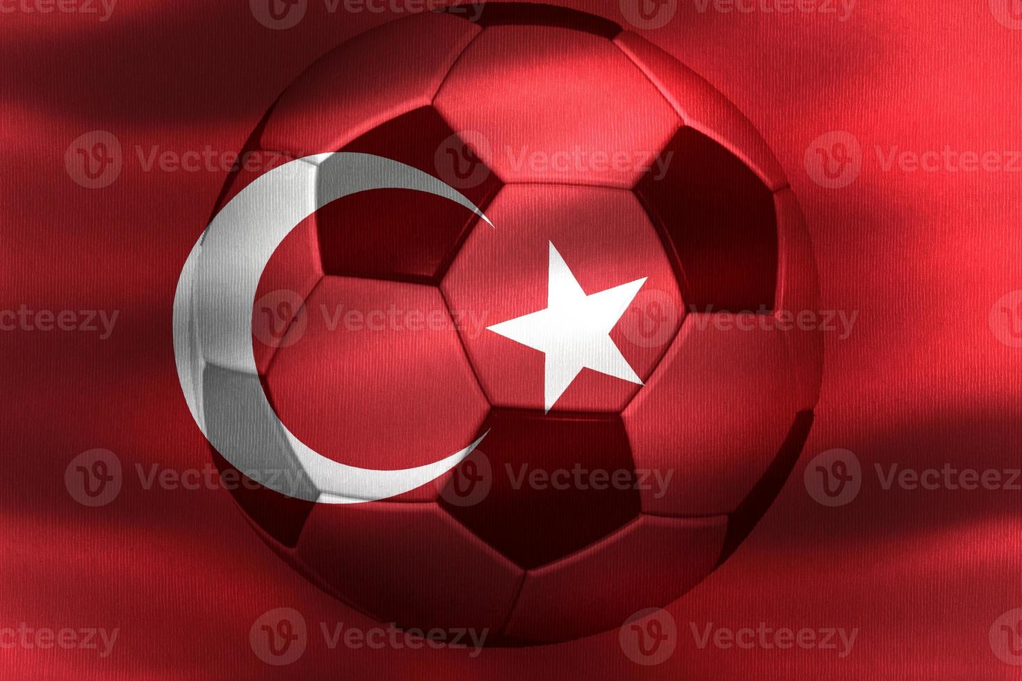 3D-Illustration of a Turkey flag with a soccer ball moving in the wind photo