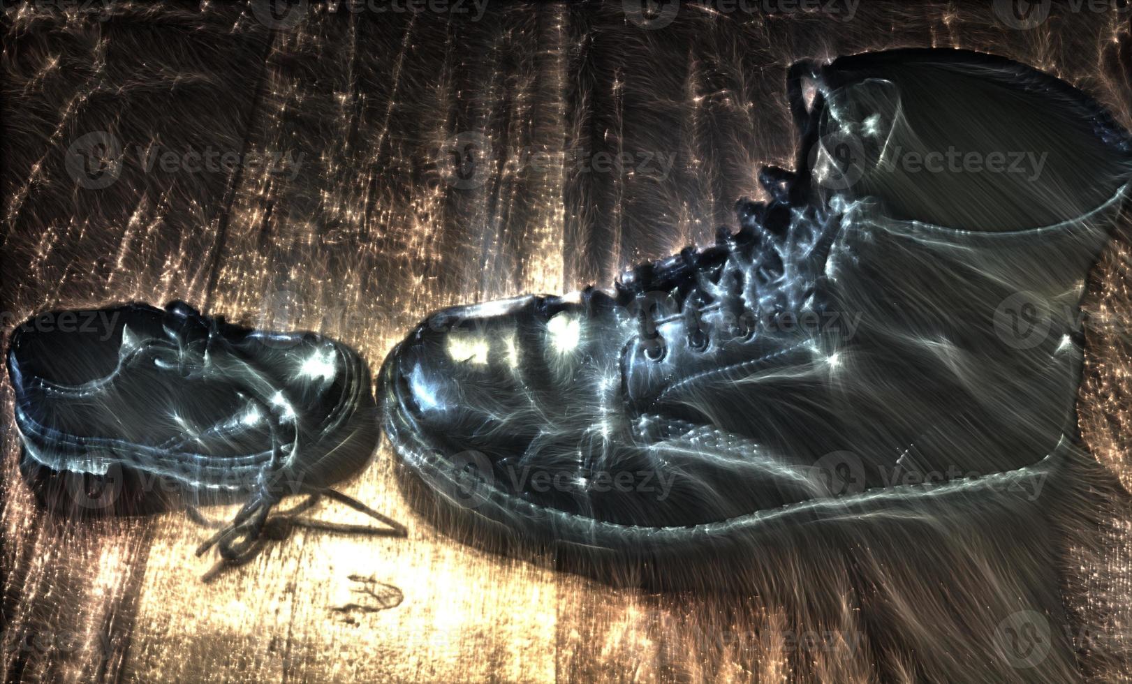 3D-Illustration of kirlian energy on a Big and small black leather shoe on a wooden floor photo