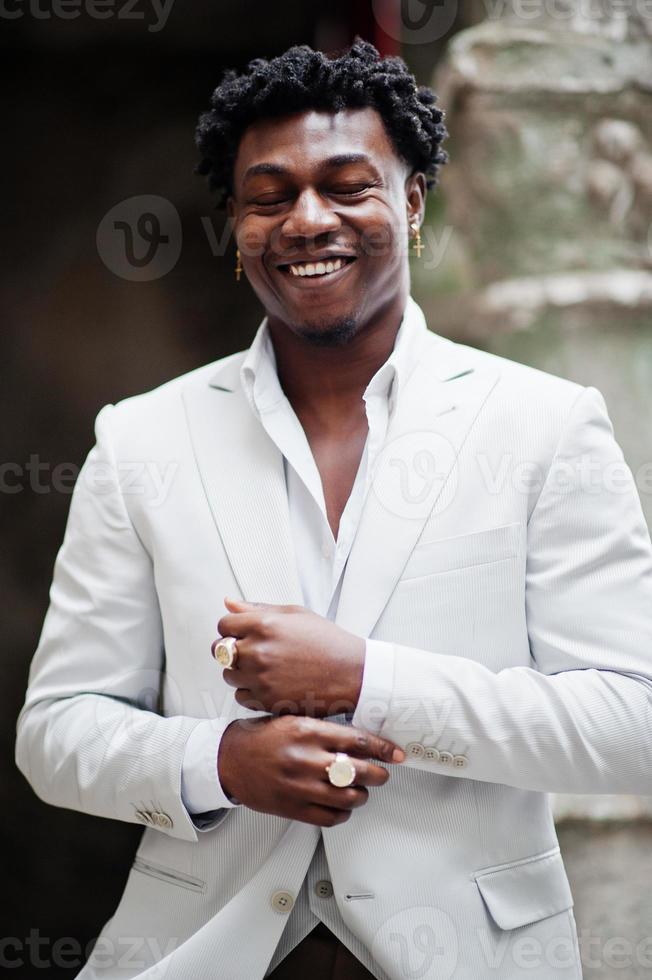 Thoughtful young handsome african american gentleman in formalwear. Black stylish model man in white jacket. photo