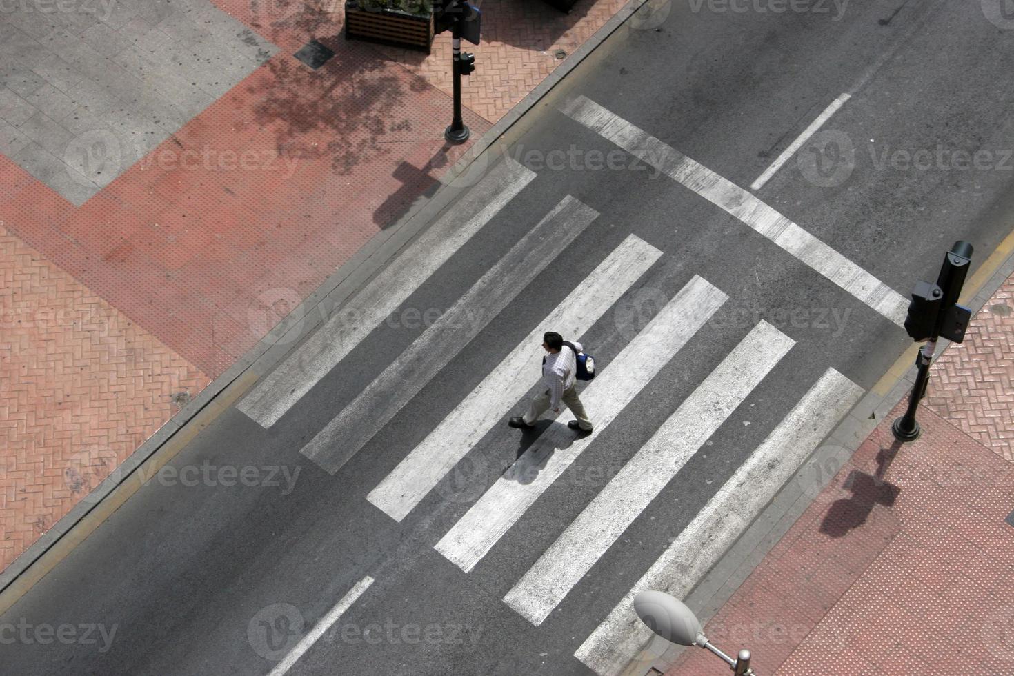 crosswalk with a person, crosswalk on the street, pedestrian crossing in the city photo