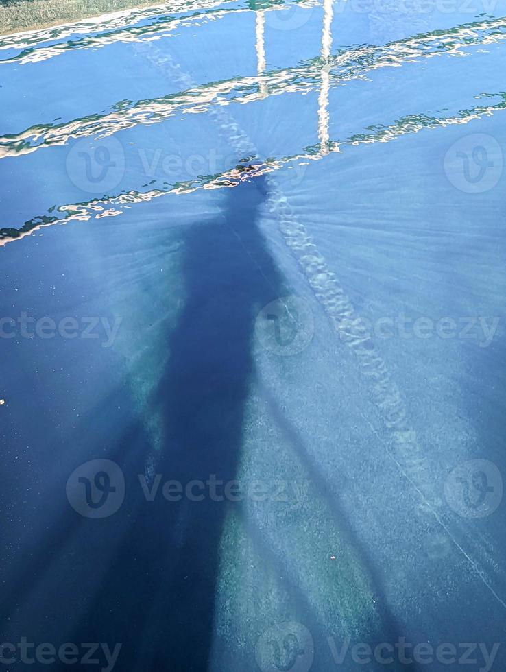 shadow of a person in pool of water photo