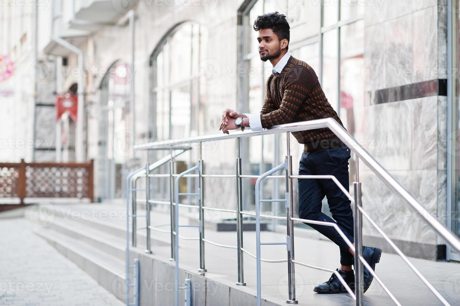 Portrait of young stylish indian man model pose in street. photo