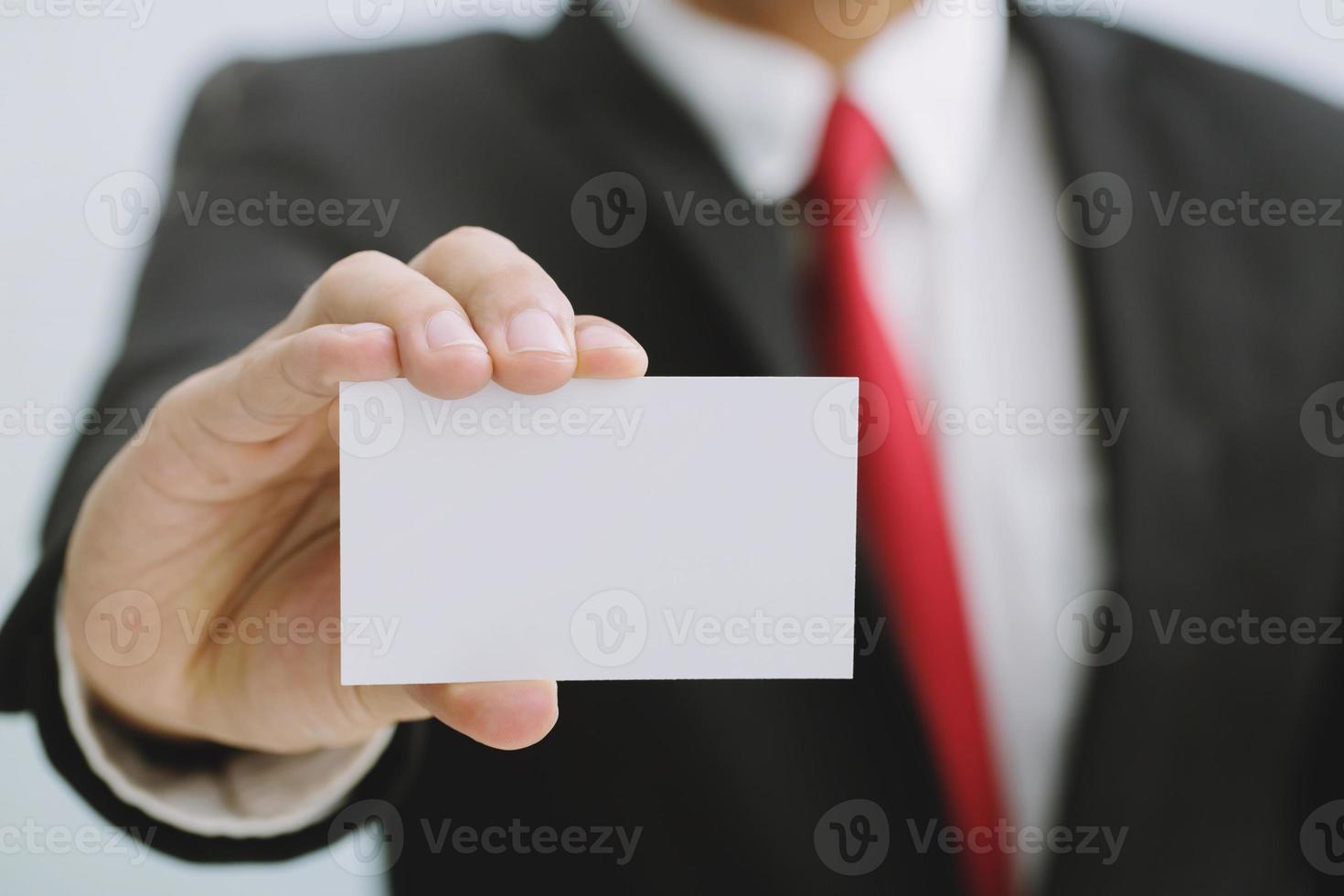 Young businessman who takes out blank business card from the pocket of his shirt business suit, copy space photo