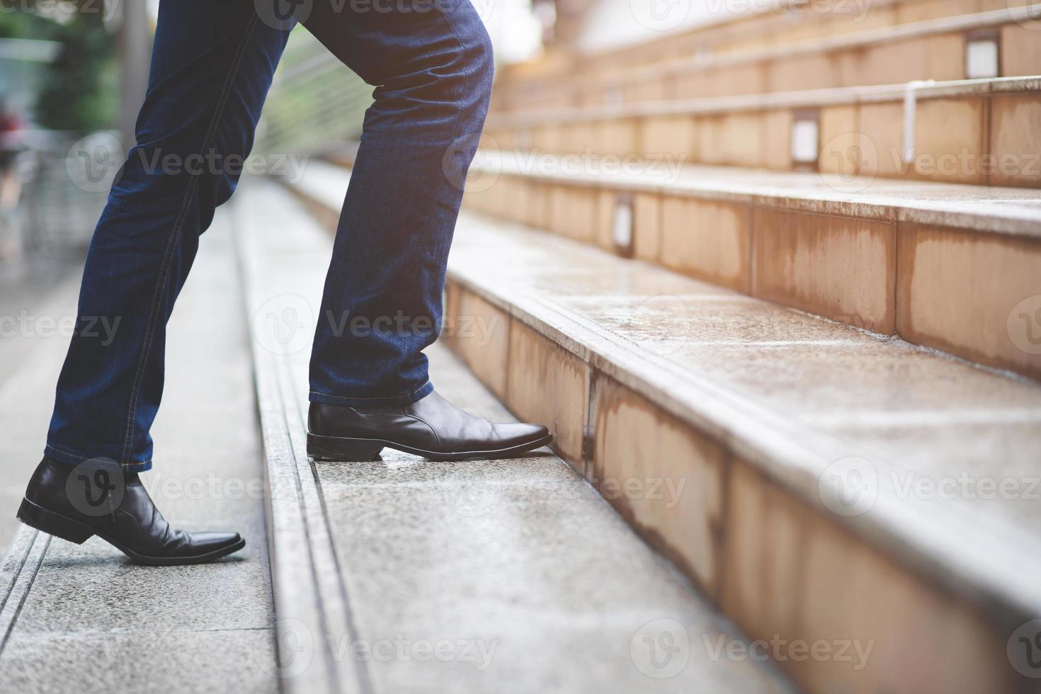 modern businessman working close-up legs walking up the stairs in modern city. in rush hour to work in office a hurry. During the first morning of work. stairway photo