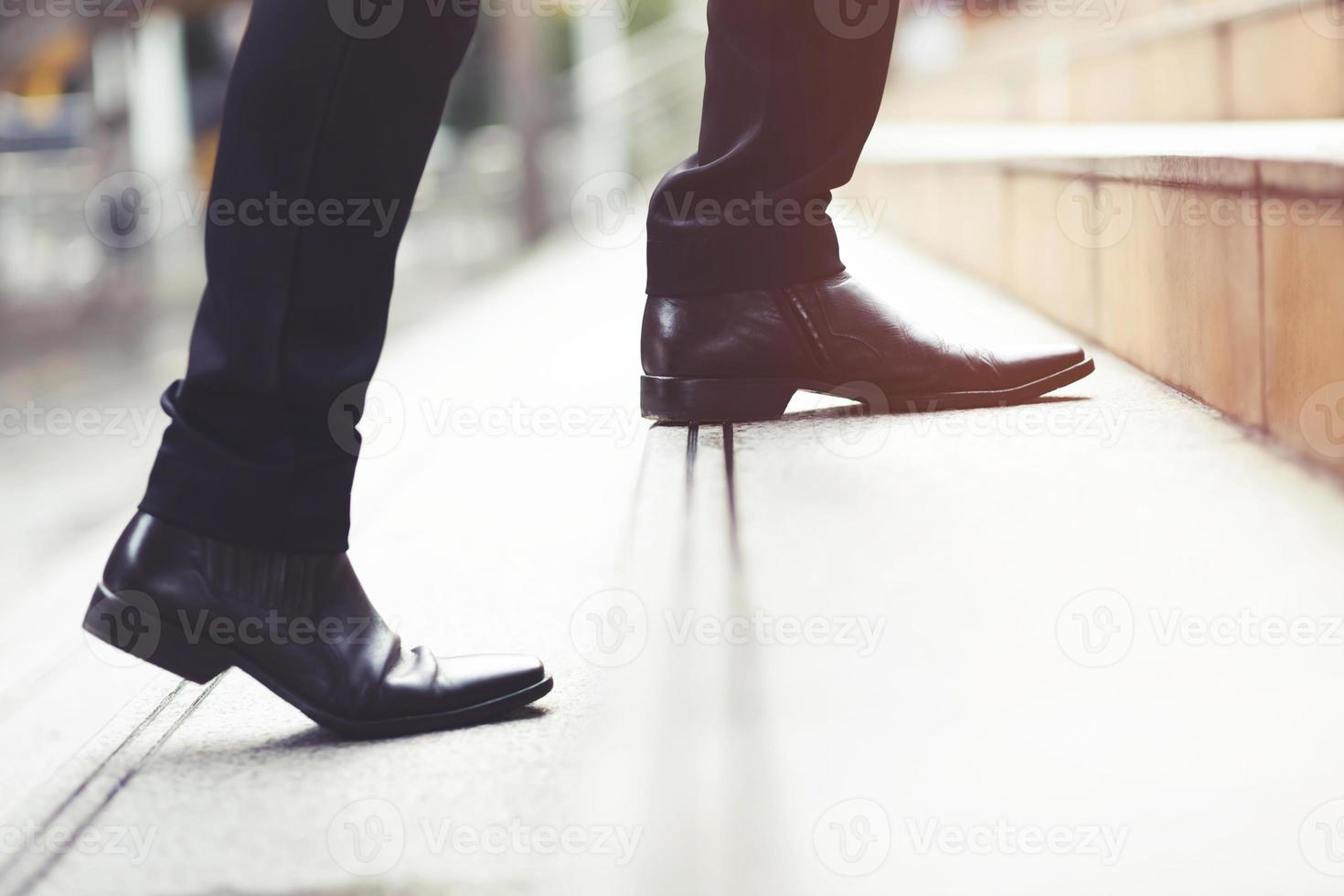 modern businessman working close-up legs walking up the stairs in modern city. in rush hour to work in office a hurry. During the first morning of work. stairway. soft focus. photo