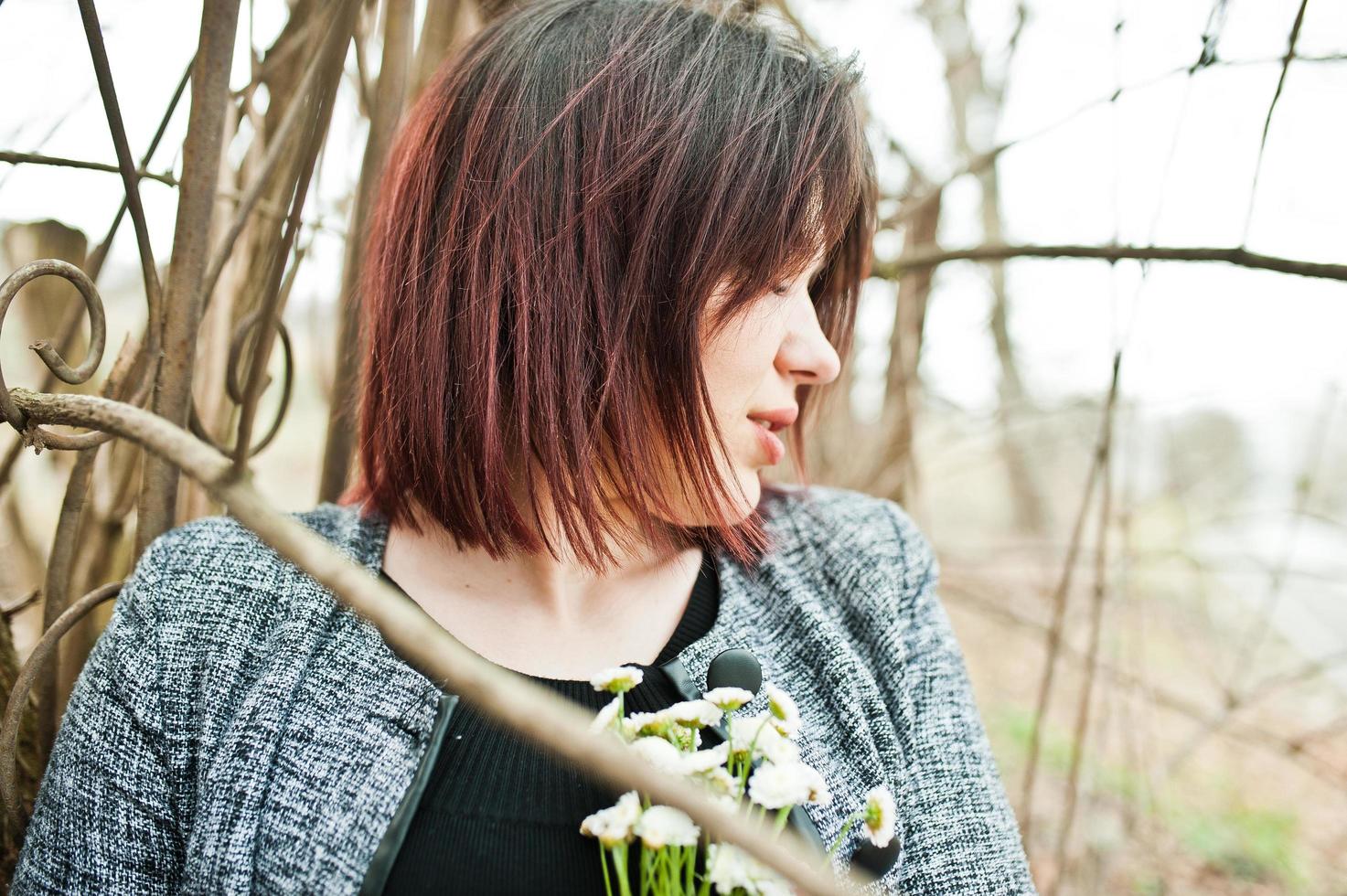 Portrait of brunette girl in black dress at spring wood. photo