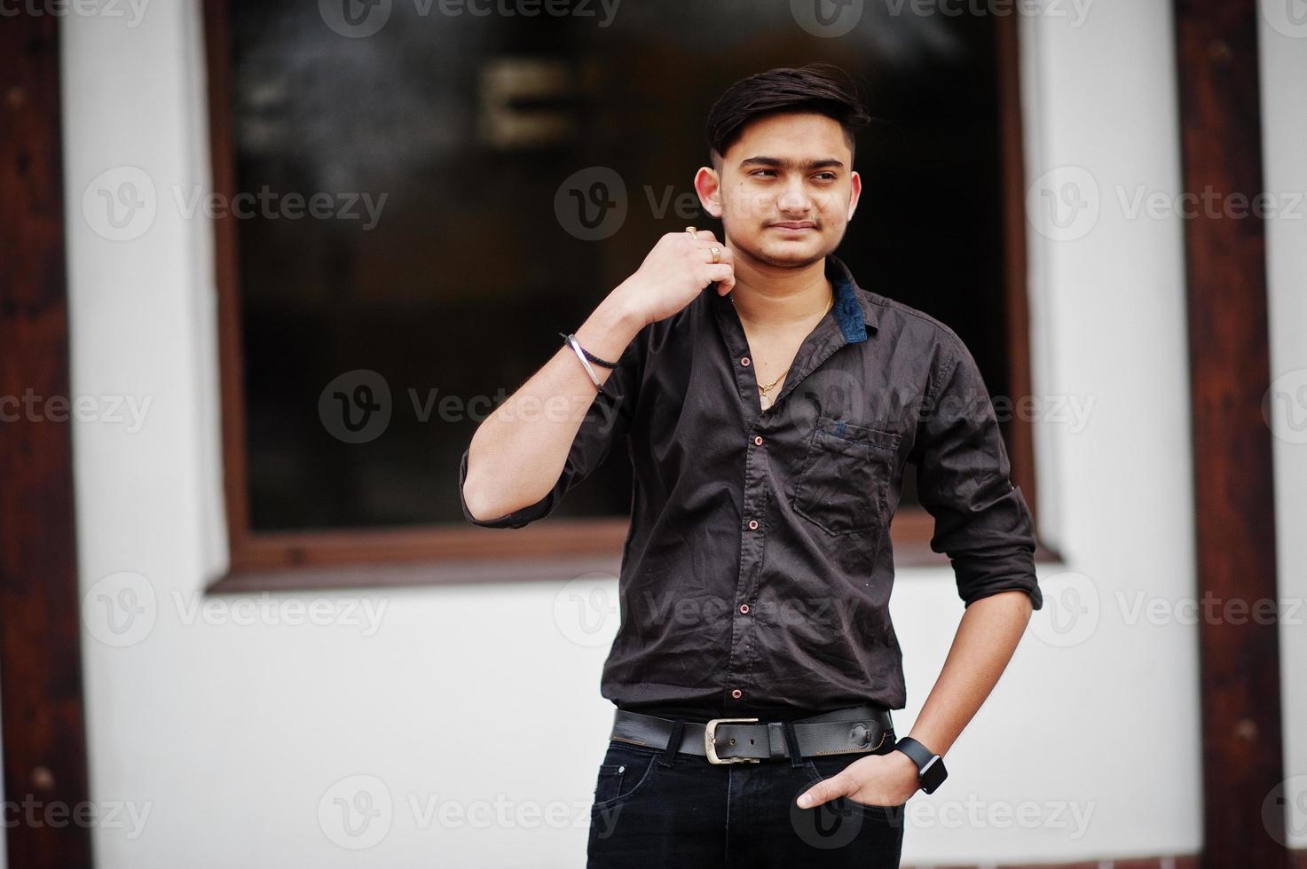Indian man in brown shirt posed outdoor. photo