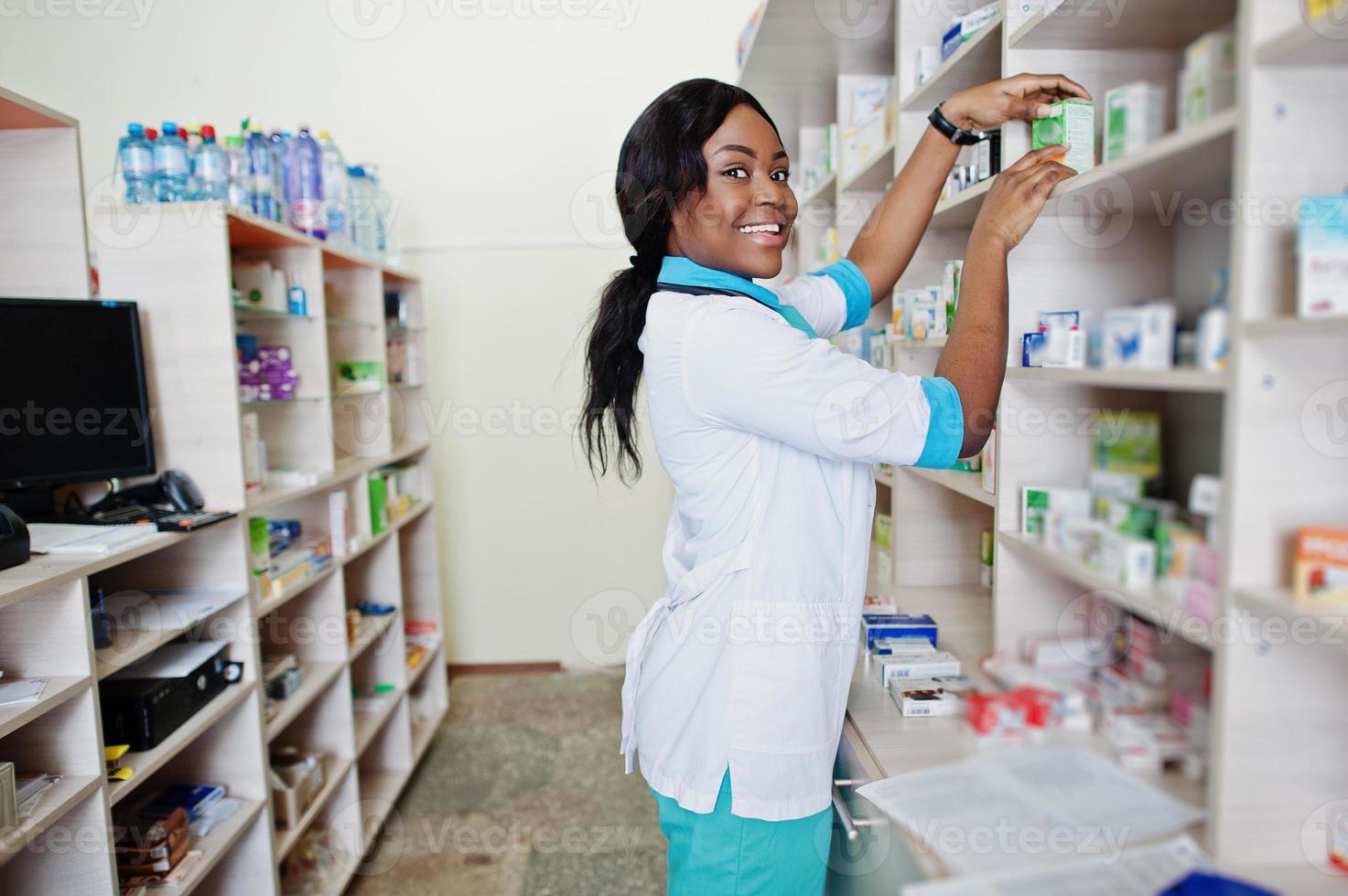 African american pharmacist working in drugstore at hospital pharmacy. African healthcare. photo