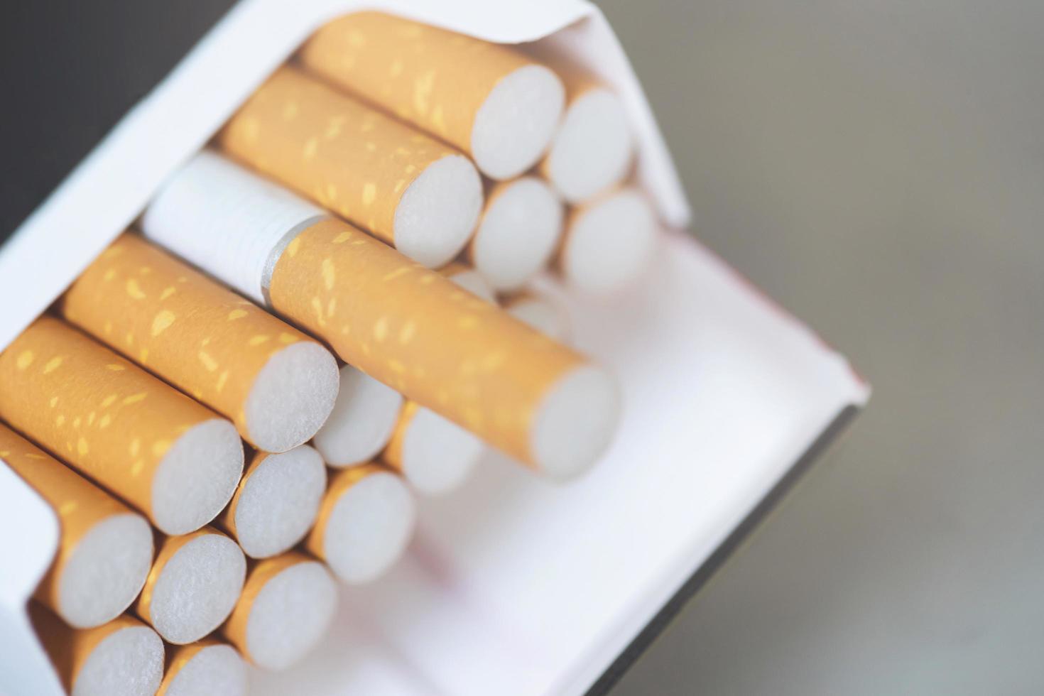 peel it off Cigarette pack prepare smoking on white wooden background. Packing line up. photo filters Natural light.