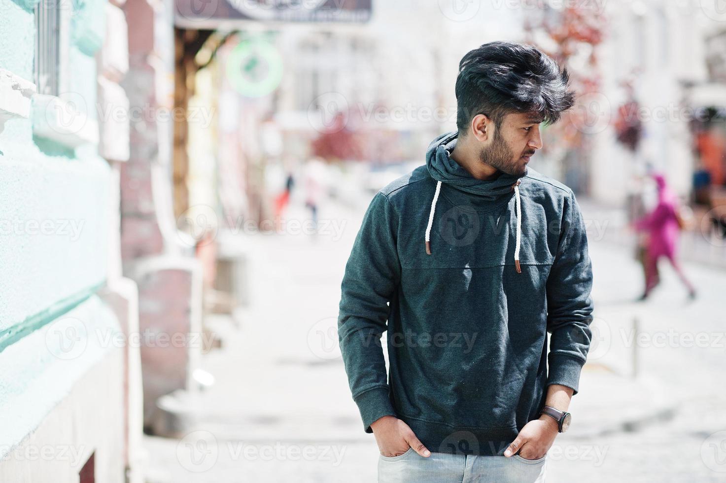 Portrait of young stylish indian man model pose in street. photo