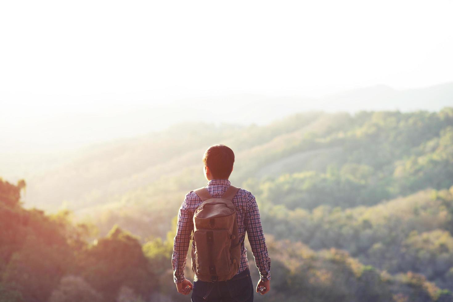 Man hiking at sunset mountains with heavy backpack Travel Lifestyle wanderlust adventure concept summer photo