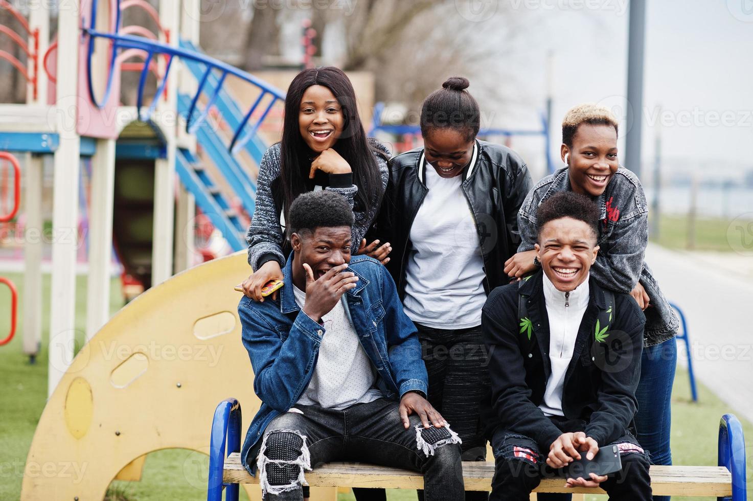 Young millennials african friends walking in city. Happy black people having fun together. Generation Z friendship concept. photo