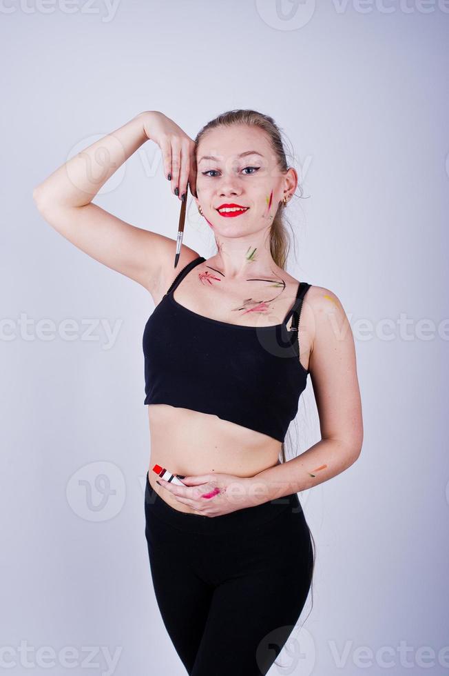 Beautiful woman artist painter with brushes posing in studio isolated on white. photo