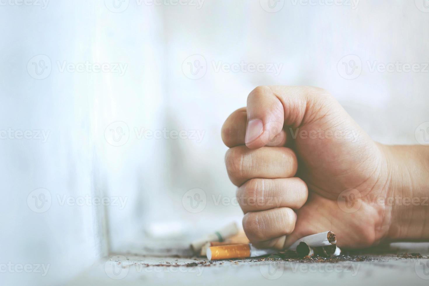 Man hand fist destroy break refusing cigarettes. concept for quitting smoking and healthy lifestyle. photo