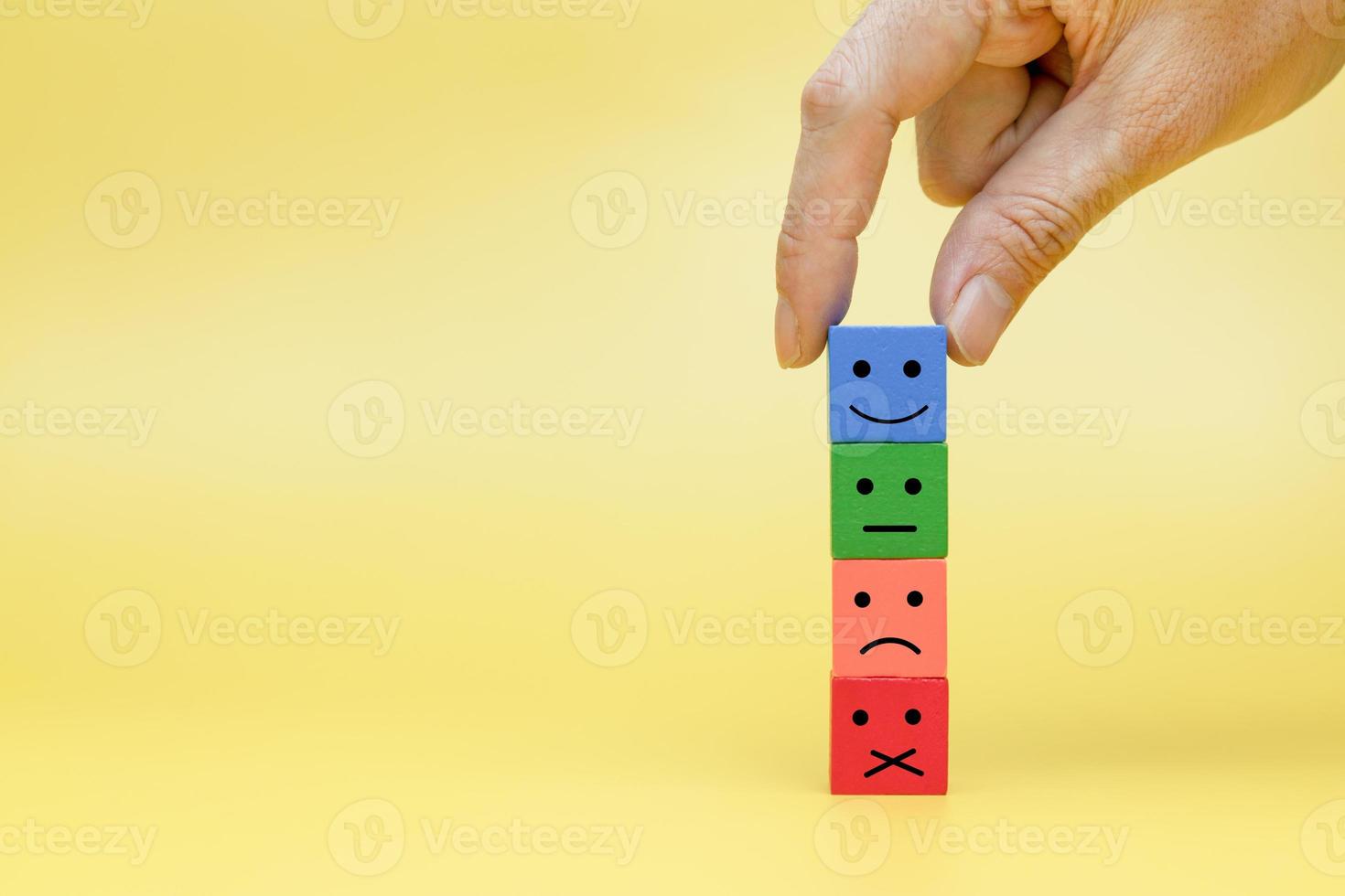 Customers reaction by choosing symbols. Stack multicolor wooden block with symbol emotion photo