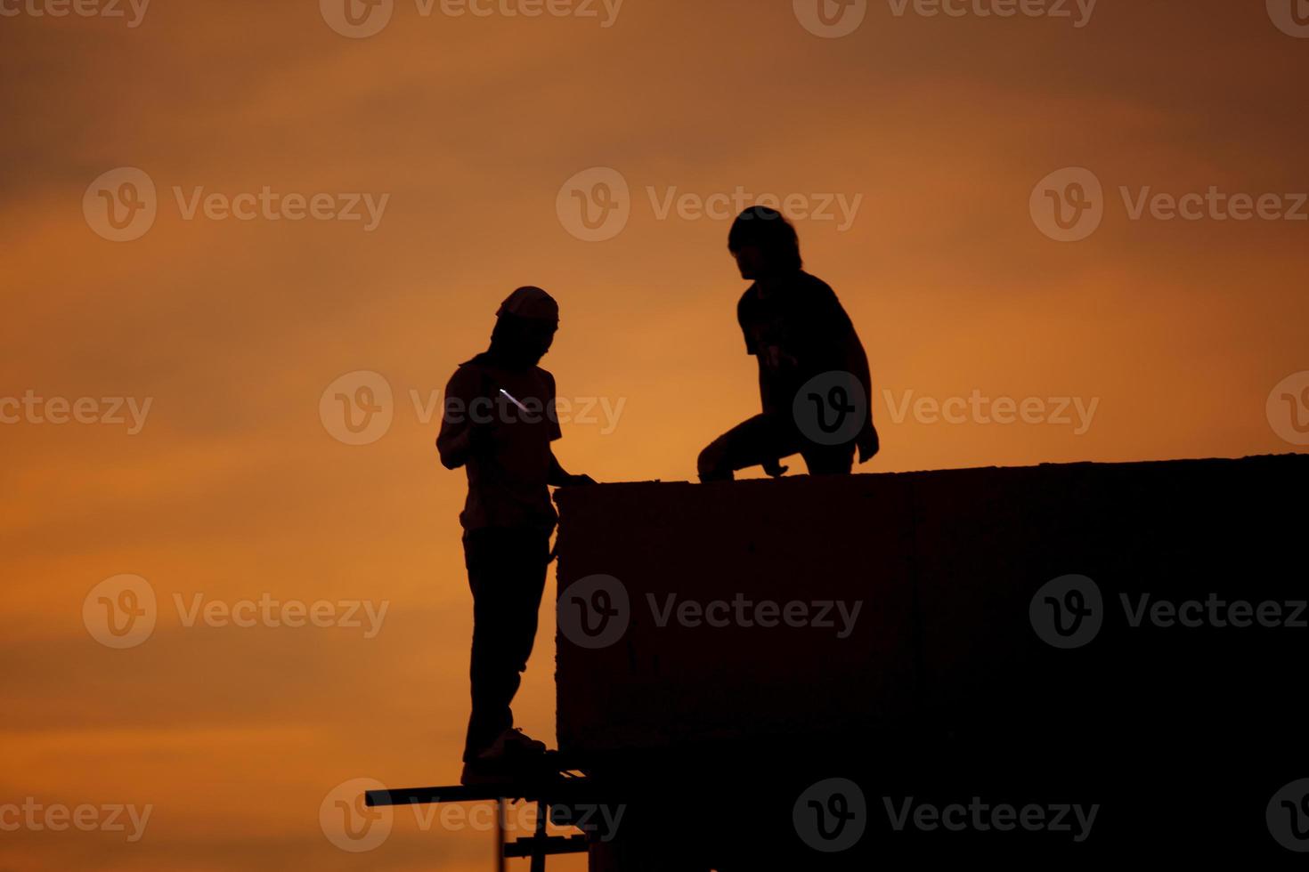 Silhouettes of worker welder photo