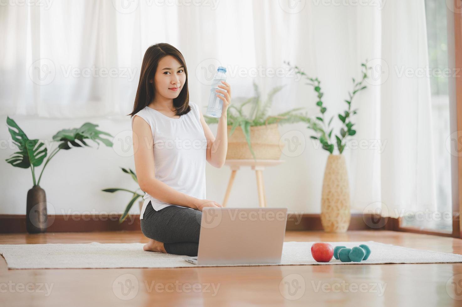 drinking water while workout at home photo