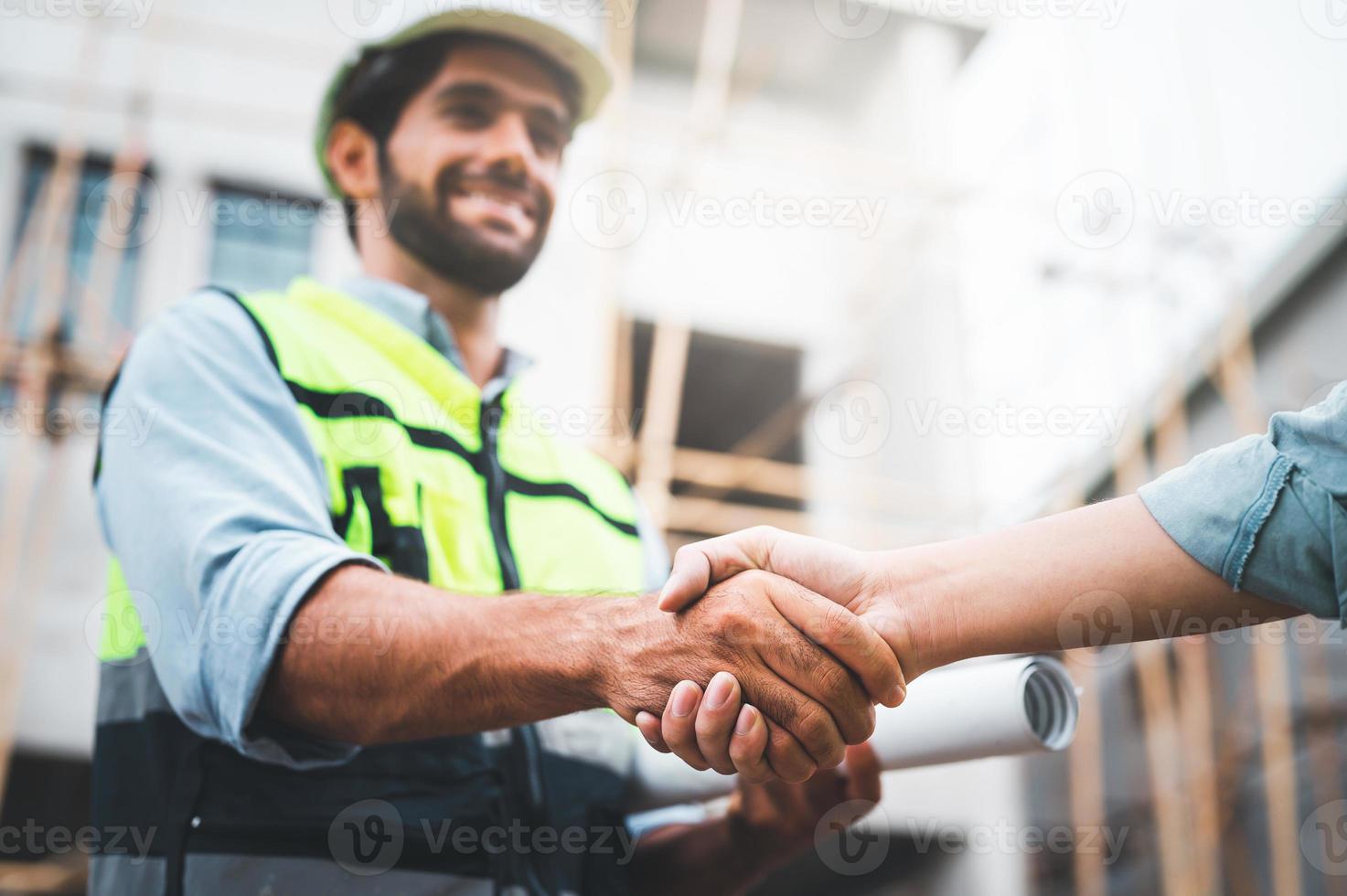 construction workers shaking hands photo