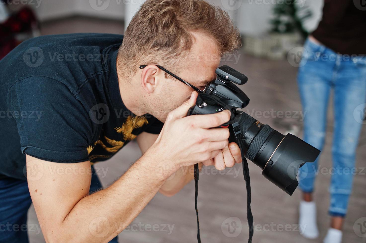 Man photographer shooting on studio. Professional photographer on work. photo