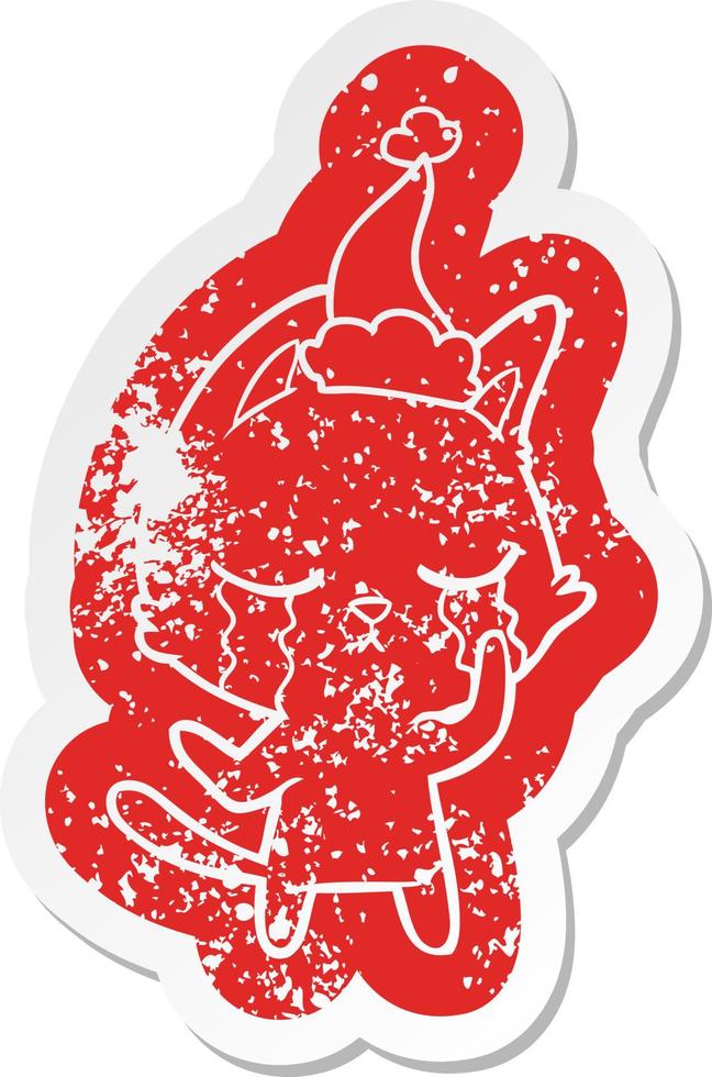 crying cartoon distressed sticker of a cat wearing santa hat vector