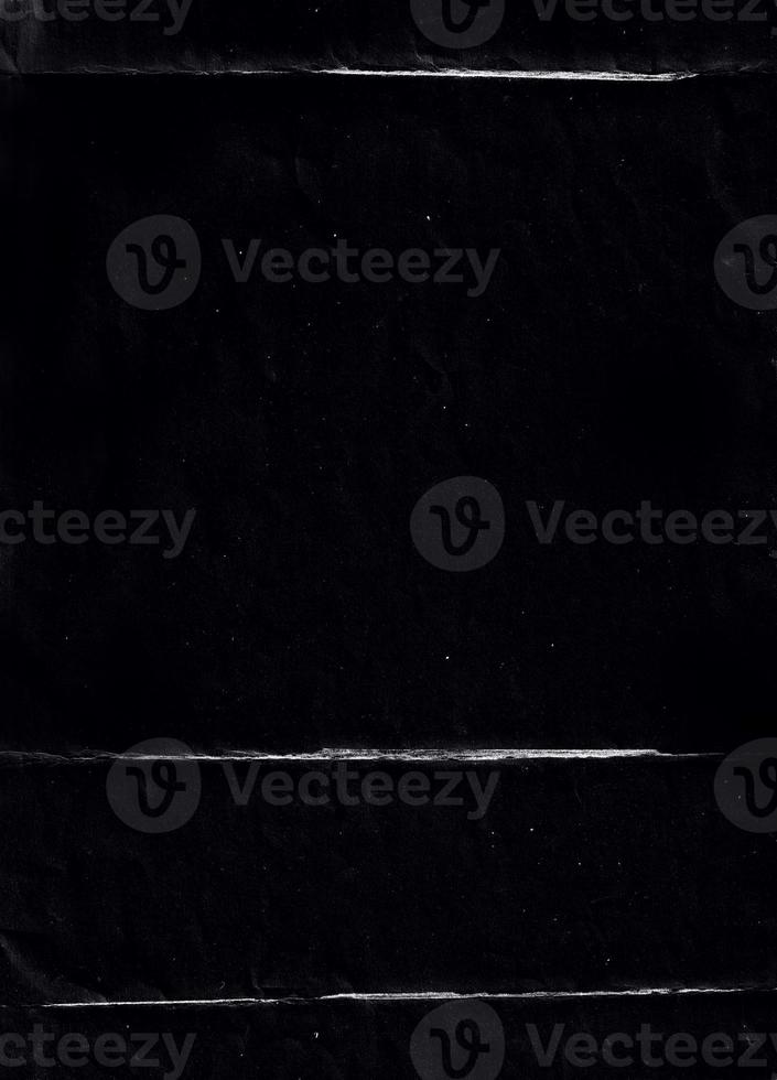 Folded paper with grungy texture in black background. can be used to replicate the aged and worn look for your creative design. old paper for photo texture overlay in retro style