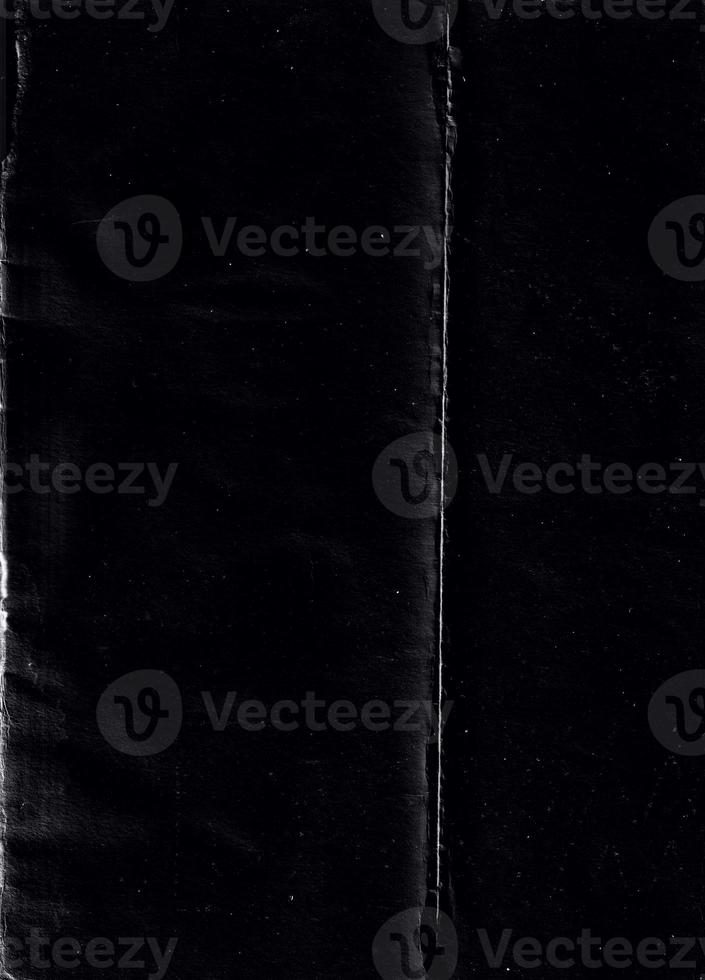 Folded paper with grungy texture in black background. can be used to replicate the aged and worn look for your creative design. old paper for photo texture overlay in retro style