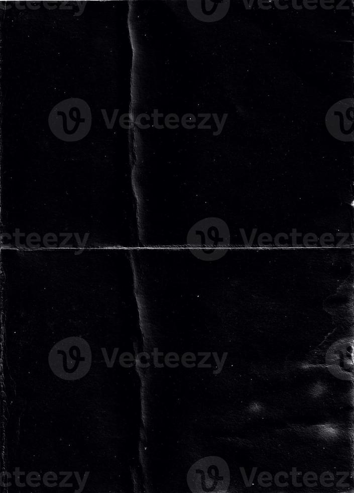 Folded paper with grungy texture in black background. can be used to replicate the aged and worn look for your creative design. old paper for photo texture overlay in retro style