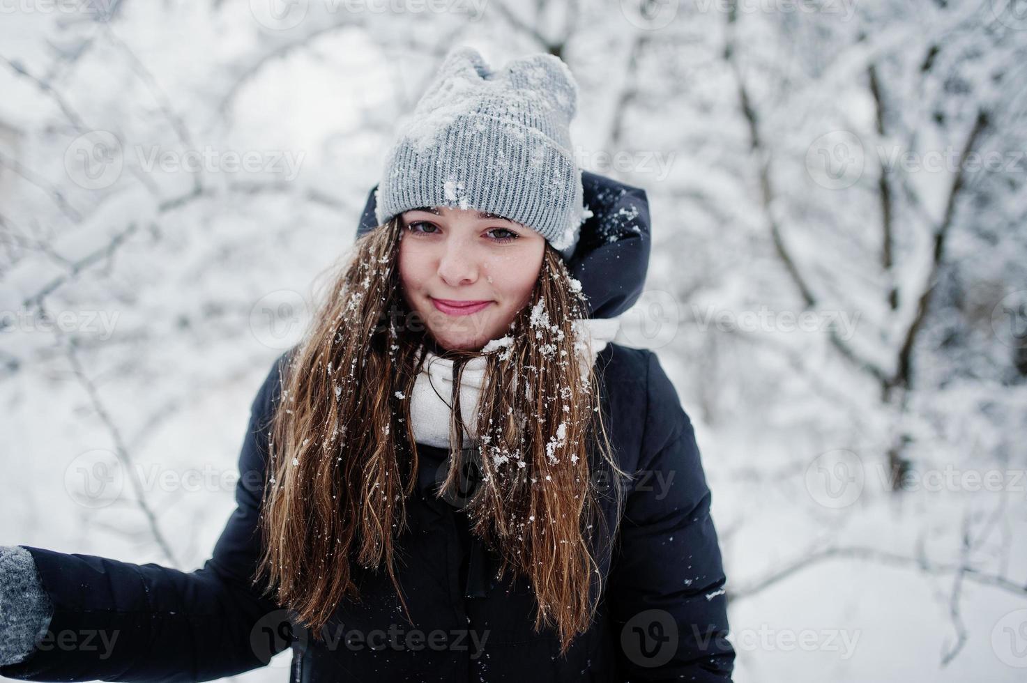 Two funny girls friends having fun at winter snowy day near snow covered trees. photo