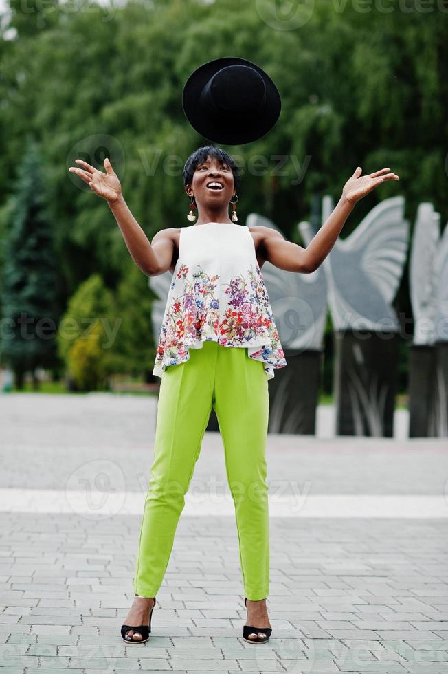 Amazing african american model woman in green pants posed at park