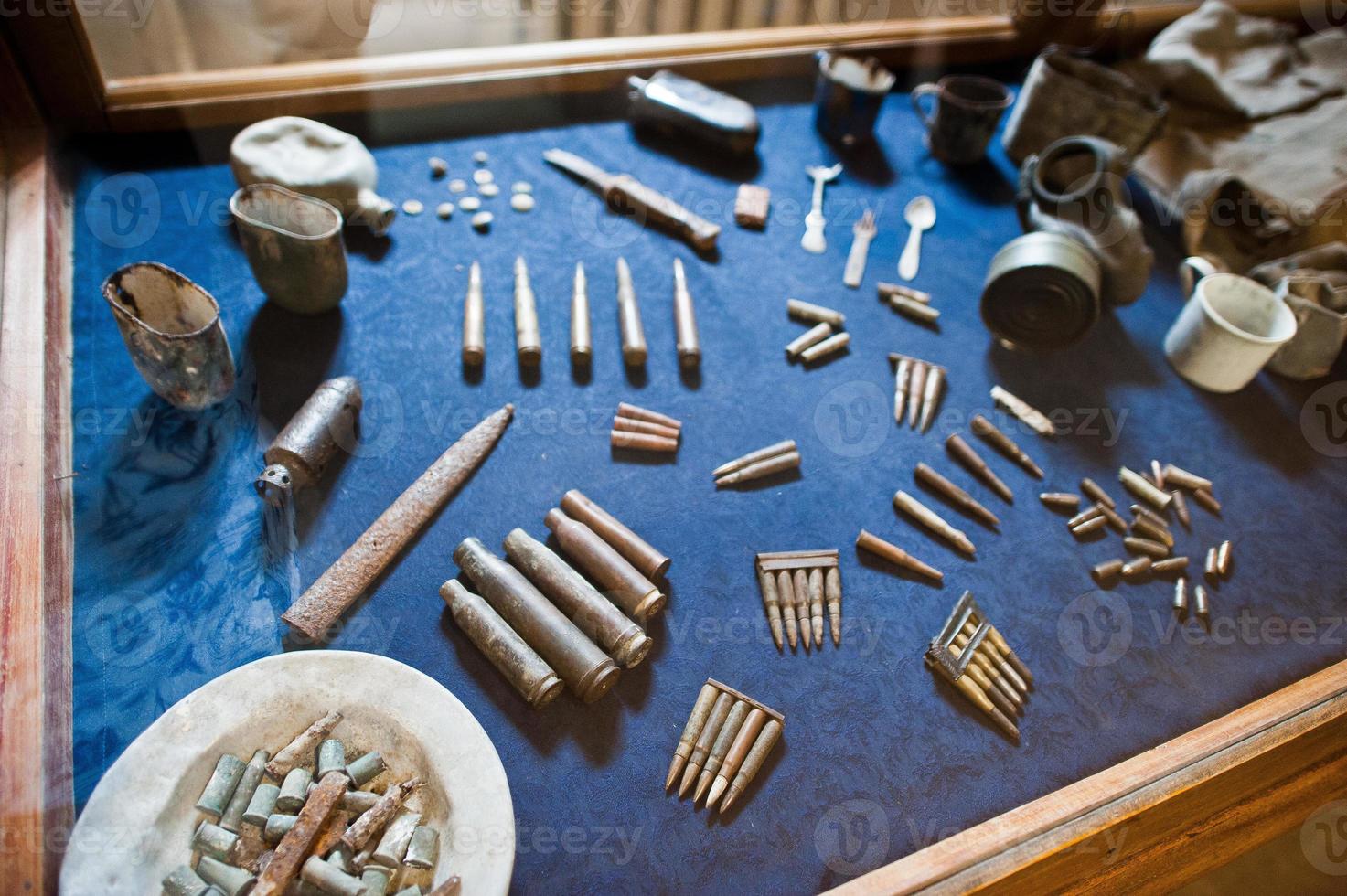 Variety of bullets on the blue surface in museum. photo