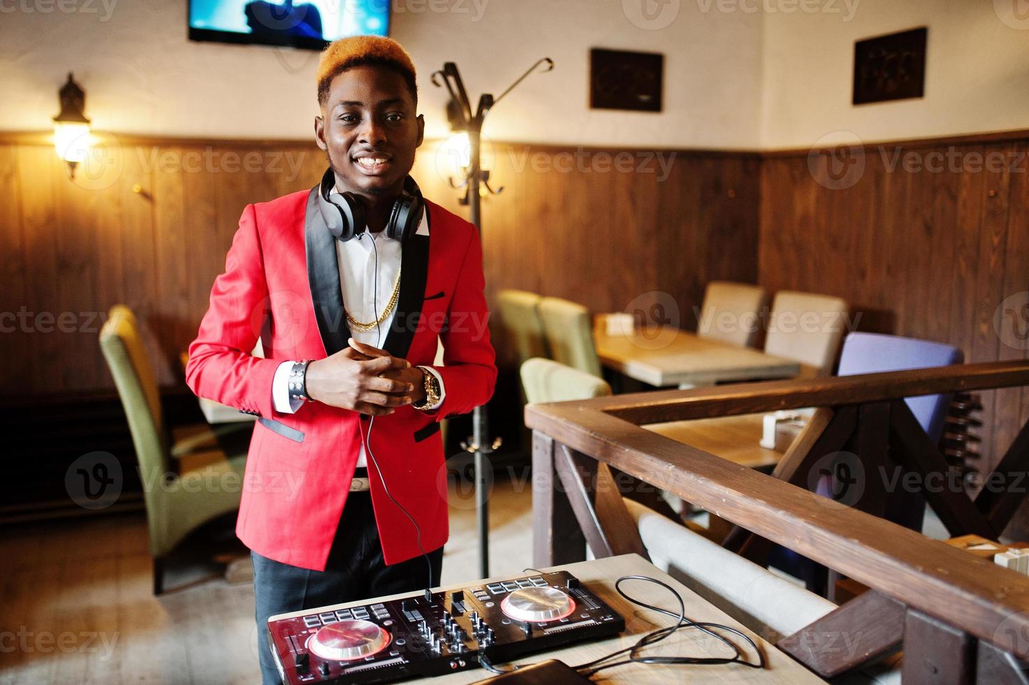Fashion african american man model DJ at red suit with dj controller. photo