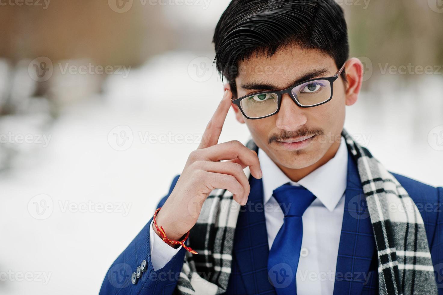Close up portrait of stylish indian student man in suit, glasses and scarf posed at winter day outdoor. photo