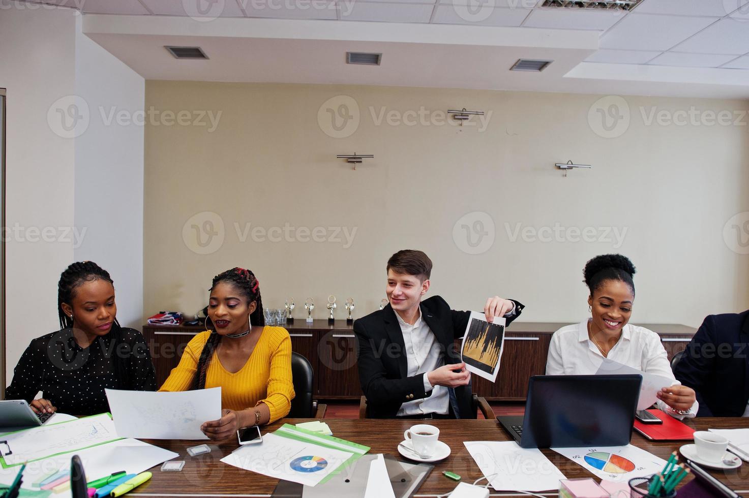 Multiracial young creative people in modern office. Group of young business people are working together with laptop, tablet. Successful freelancers team in coworking. photo