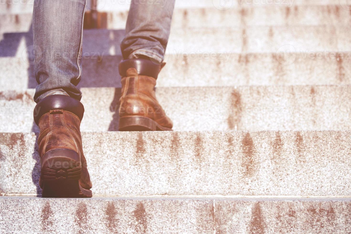 modern businessman working  close-up legs walking up the stairs in modern city. in rush hour to work in office a hurry. During the first morning of work. stairway. soft focus. photo