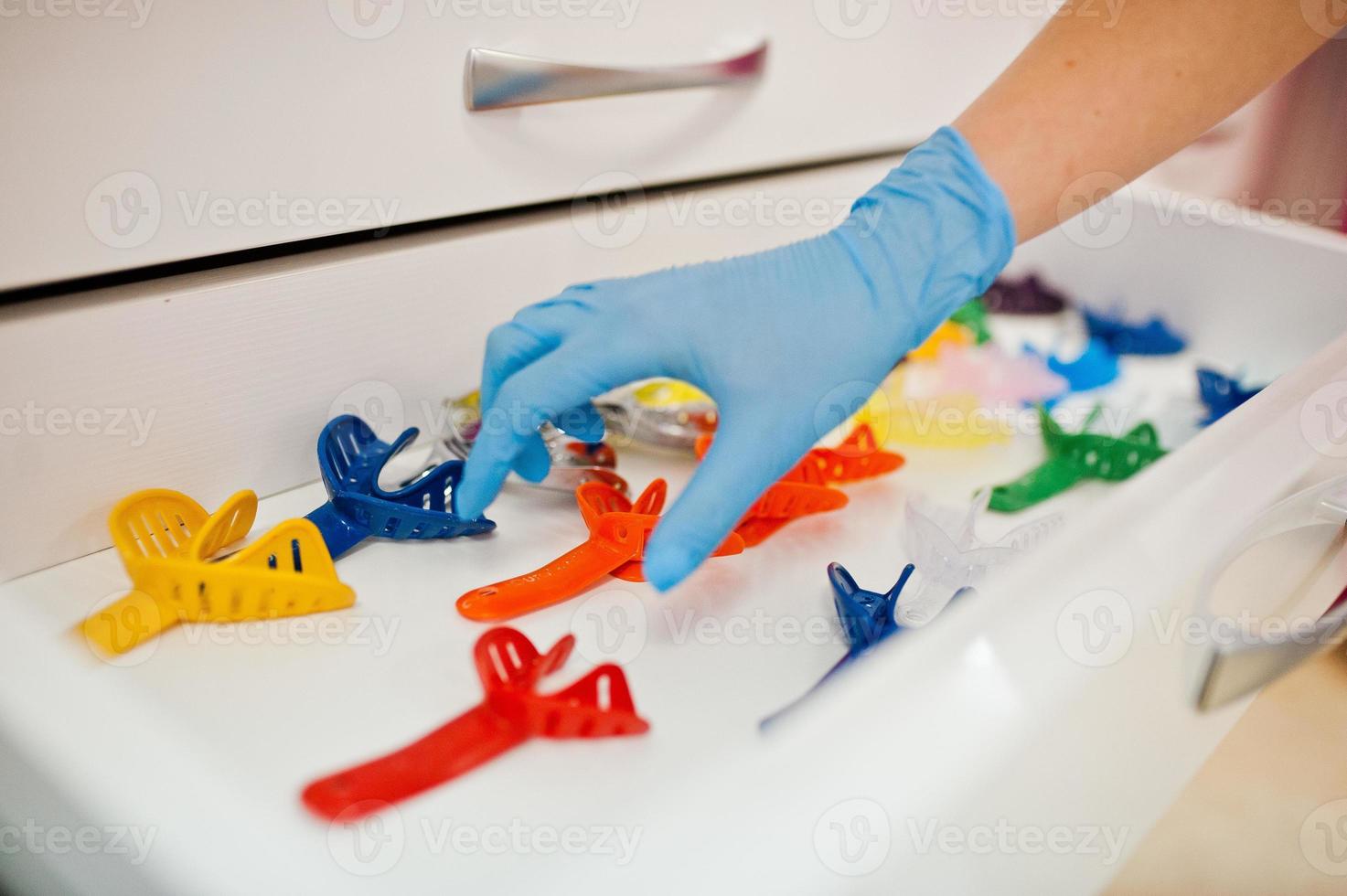 Different colored dentist tools at dental office. photo