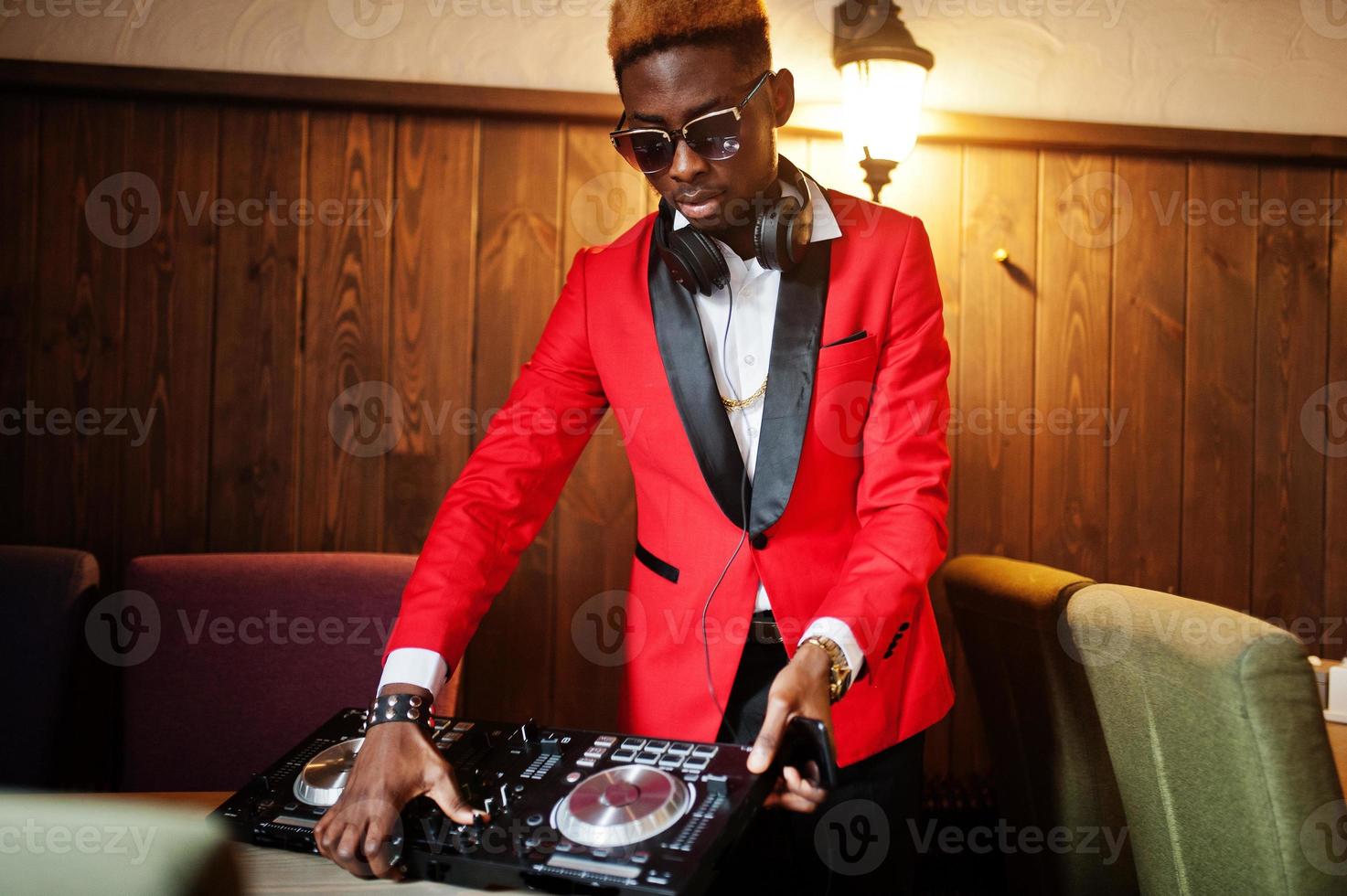 Fashion african american man model DJ at red suit with dj controller. photo