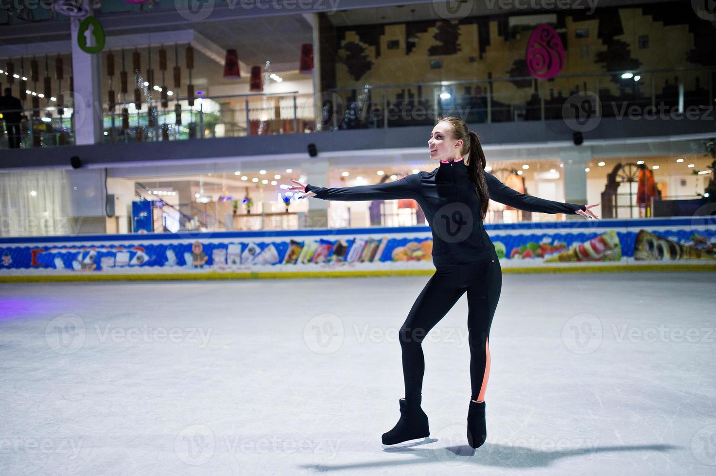 Figure skater woman at ice skating rink. photo