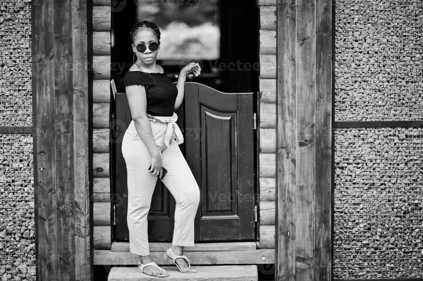 Stylish african american woman at sunglasses posed outdoor. photo