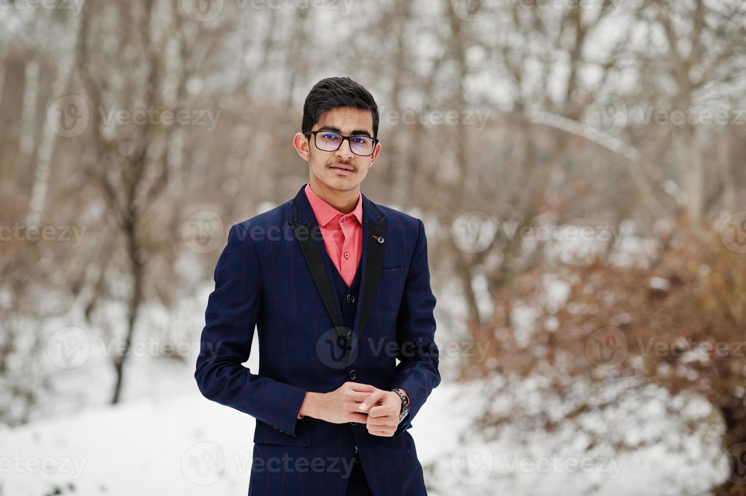 Stylish indian student man in suit and glasses posed at winter day outdoor. photo