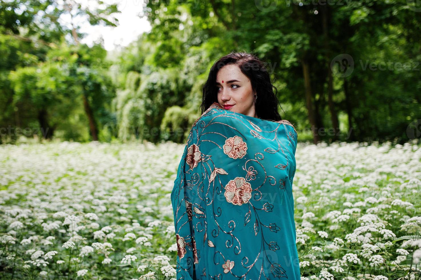 Portrait of beautiful indian brumette girl or hindu woman model. Traditional Indian costume lehenga choli. photo