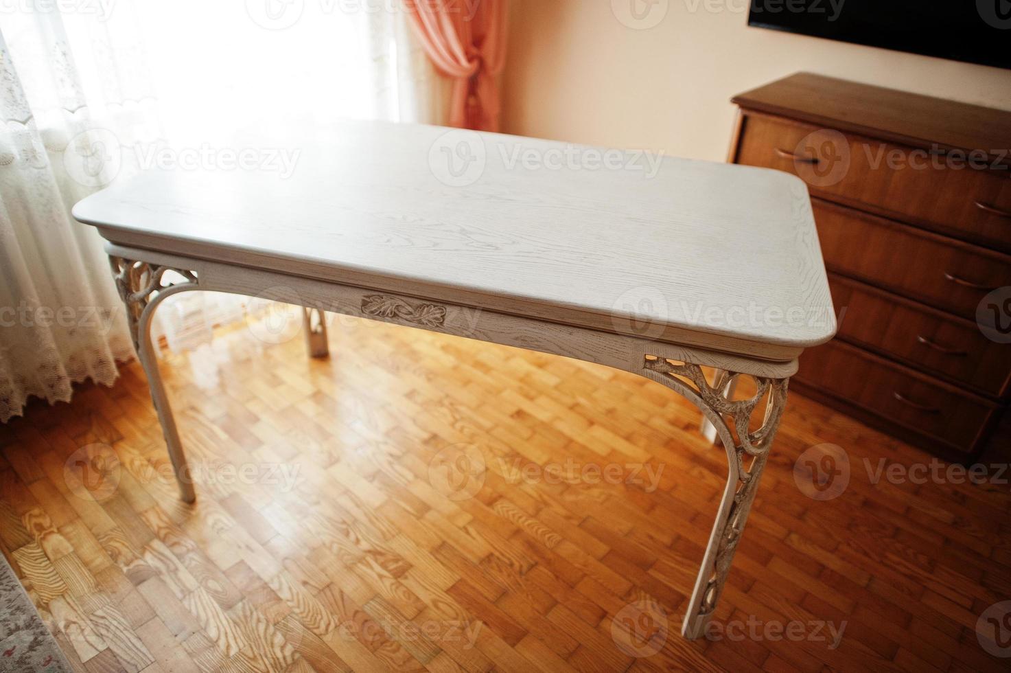 White wooden carved table in flat. photo